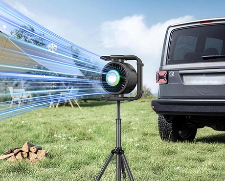 Outdoor camping fan on tripod blowing cool air beside SUV vehicle